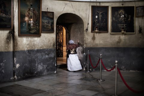 Image: An eastern European pilgrim walks away from the Armenian section of the Church of the Nativity in the West Bank city of Bethlehem, Dec. 24, 2011.
